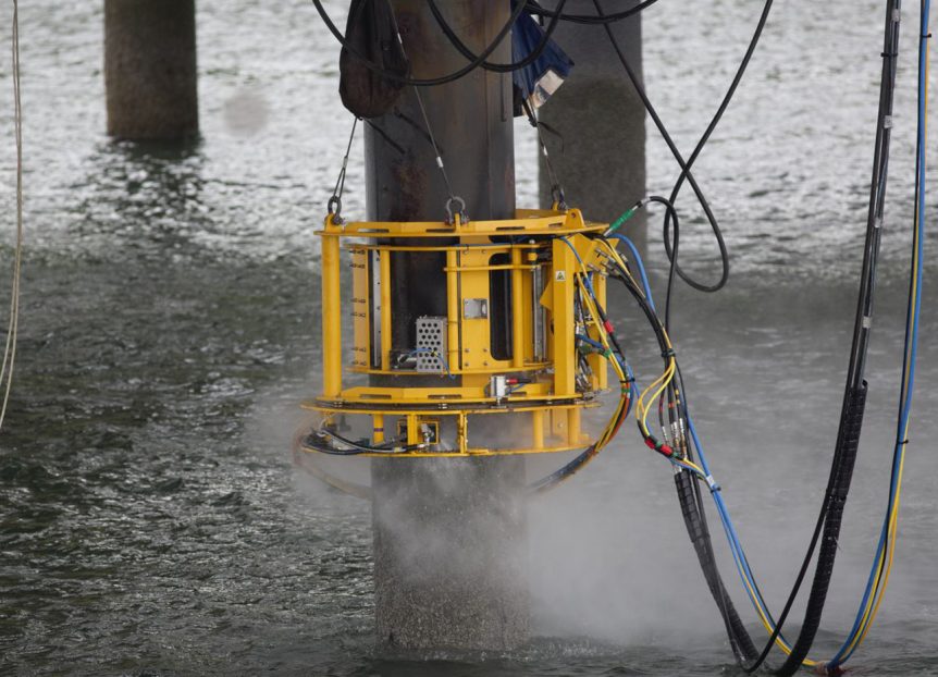 AquaTerra's AquaCLAM product being used on marine piles on the jetty loading platform at Braefoot Bay